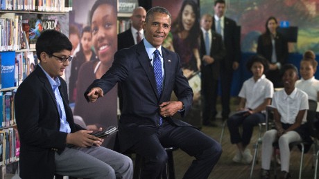 U.S. President Barack Obama (R), with student moderator Osman Yaya (L), responds to a question during a &#39;Virtual Field Trip&#39; with middle school students from around the country at Anacostia Library April 30, 2015 in Washington, DC. Students countrywide participated to discuss efforts to increase learning opportunities with improving access to digital reading content and public libraries.