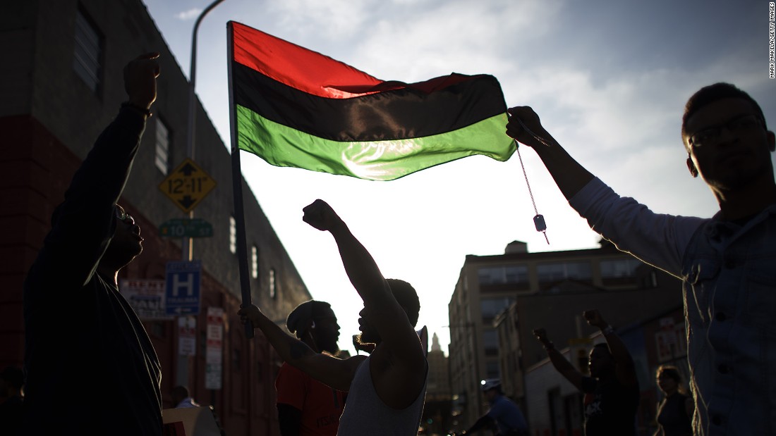 Durmel Coleman, 23, marches as the flag bearer in a Philadelphia protest over the death of Freddy Gray on Thursday, April 30. 