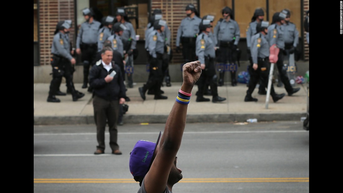 A demonstrator celebrates in Baltimore the charges were announced on May 1.