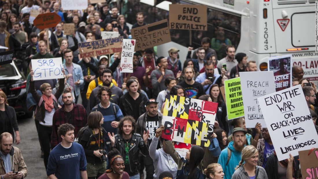 Demonstrators march through the streets of Baltimore after the charges against the officers were announced May 1. 