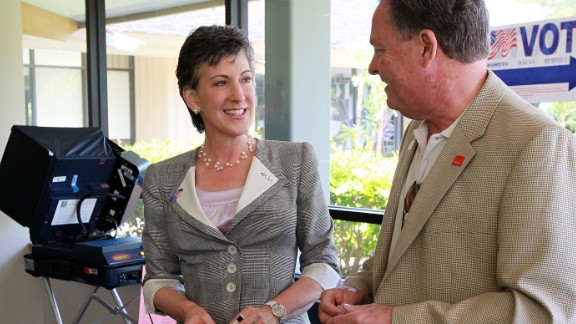 Fiorina, left, smiles with her husband Frank Fiorina, right, after casting their ballots at a polling place June 8, 2010, in Los Altos Hills, California. 