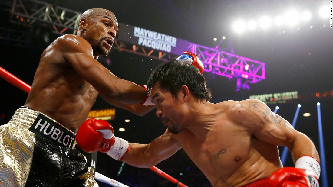Floyd Mayweather and Manny Pacquiao exchange punches on Saturday, May 2, at their championship fight in Las Vegas.