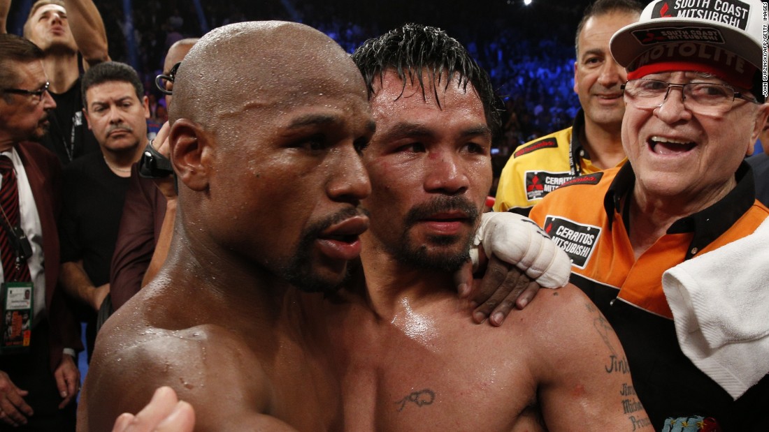 Mayweather left, hugs Pacquiao after defeating him in their welterweight unification bout.