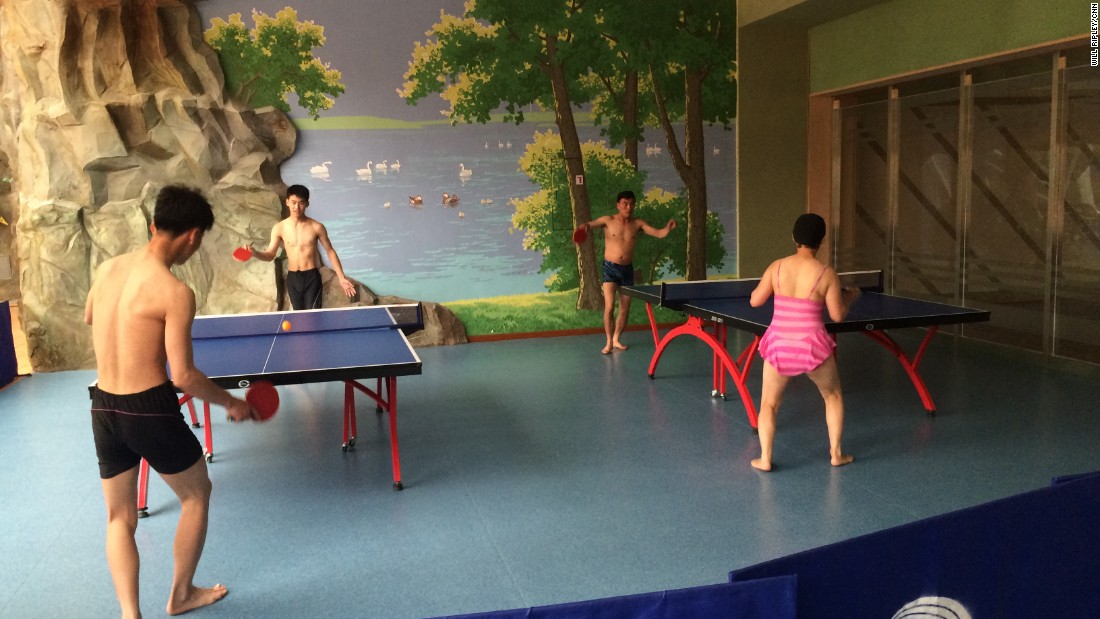 Visitors to a Pyongyang water park play table tennis.   