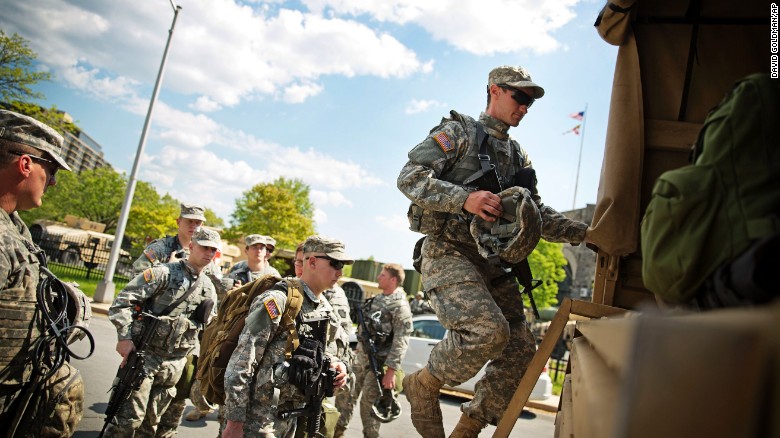 Members of the National Guard board a truck at an armory staging area Sunday, May 3, 2015, in Baltimore. after Baltimore's mayor lifted a citywide curfew.