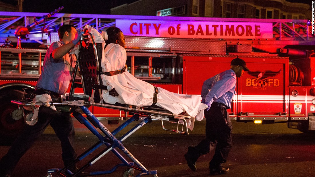 Medics take a man away after police pepper-sprayed him on Saturday, May 2, in Baltimore&#39;s Sandtown neighborhood where Freddie Gray was arrested in April.