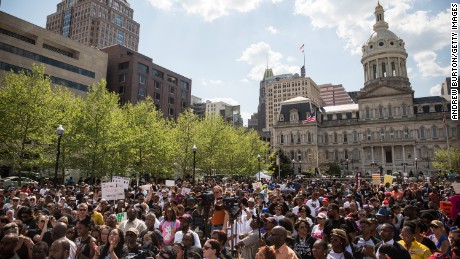 People attend a rally lead by faith leaders in front of Baltimore&#39;s city hall calling for justice in response to the death of Freddie Gray on Sunday May 3.