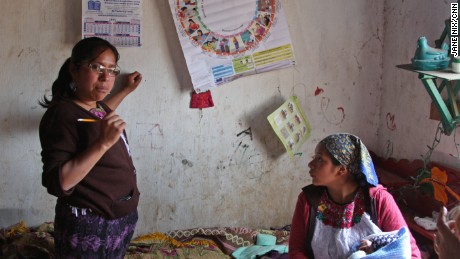 Health worker Aura Fuentes uses an illustrated wheel to help Mauricia keep track of her progress.
