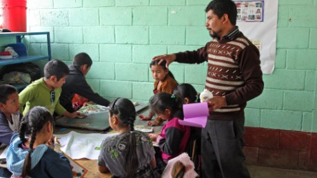 Teacher Adelfo Xalin Leon instructs his class on the basics of nutrition education, explaining which foods are healthful and which are essentially empty calories.