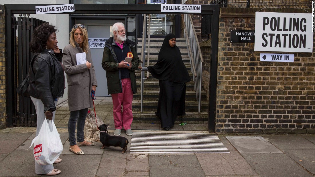 A woman leaves a polling station in the Islington neighborhood of London.