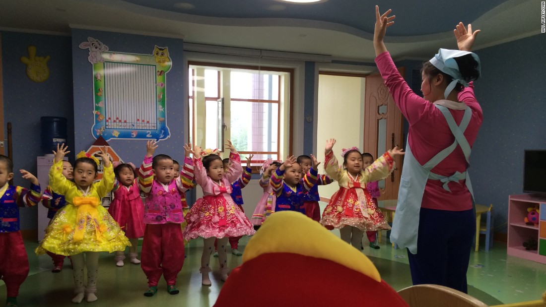 Young children in a newly constructed Pyongyang orphanage practice a musical performance.