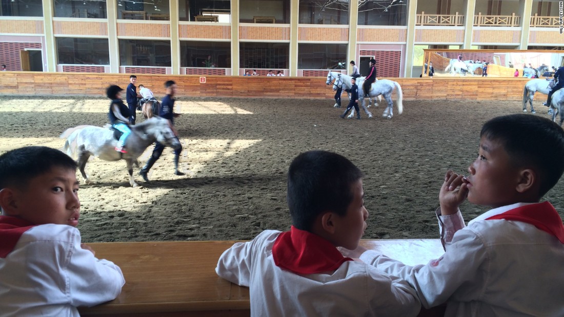 North Korean students watch riding lessons at a new equestrian center designed by Supreme Leader Kim Jong Un. The facility was formerly used for military training.