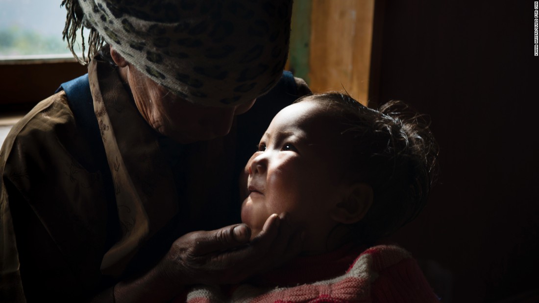 The mother of Dawa Chiri Sherpa cares for his 18-month-old daughter after the climbing guide was killed by a quake-triggered avalanche at Everest Base Camp.