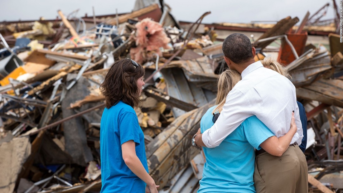 Hugging Amy Simpson, principal of Plaza Towers Elementary School, while viewing the remains of the school after a tornado in Moore, Oklahoma, on May 26, 2013.