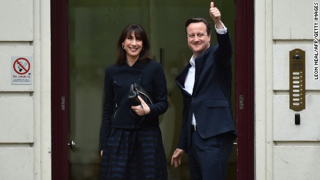 British Prime Minister and Leader of the Conservative Party David Cameron and his wife Samantha arrive at the Conservative Party headquarters in London on May 8.