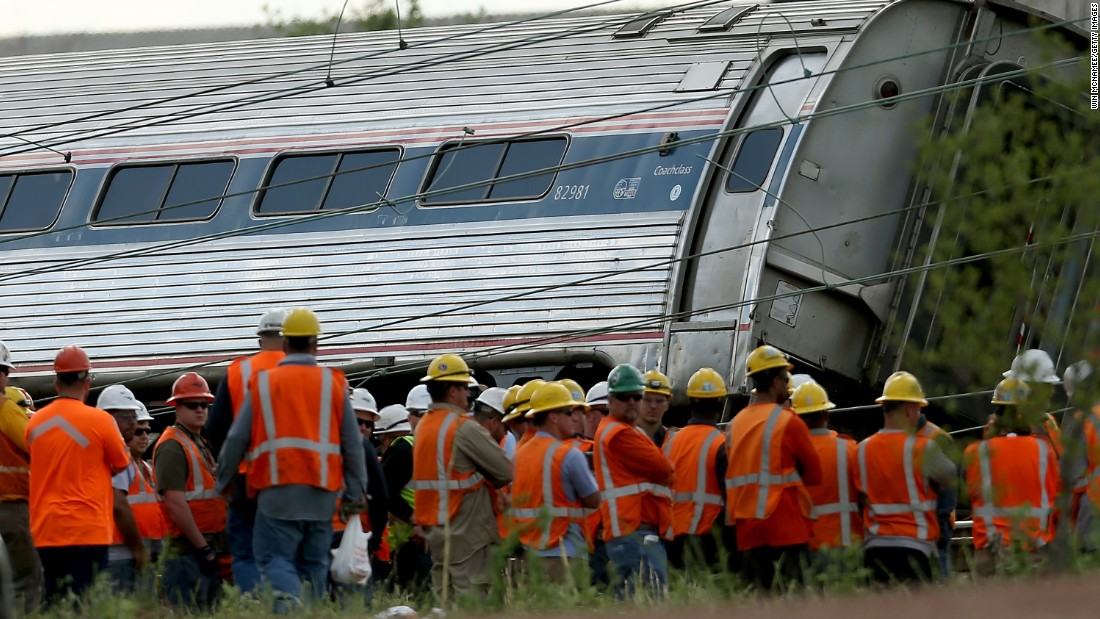 Workers stand near the wreckage on May 13.