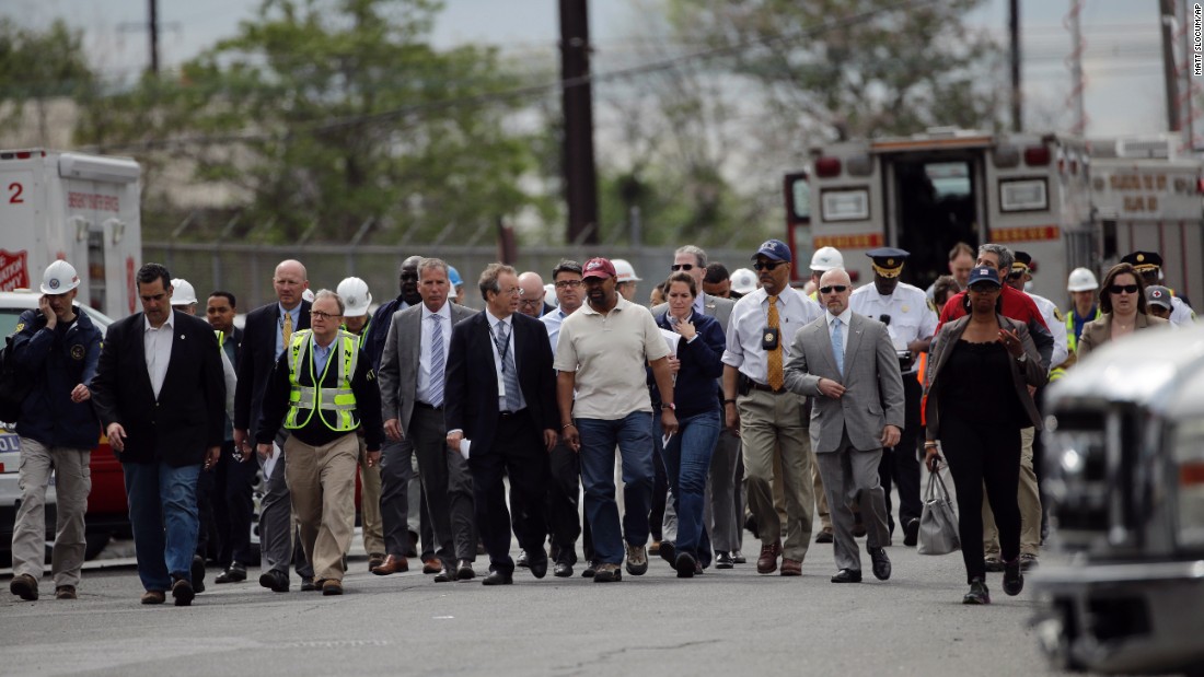 Philadelphia Mayor Michael Nutter, at center in the maroon hat, walks with other officials to a news conference near the crash site on May 13.