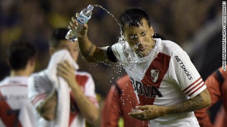 Former River defender Leonel Vangioni pours water on his face after being pepper-sprayed in 2015, as he came out for the second half.