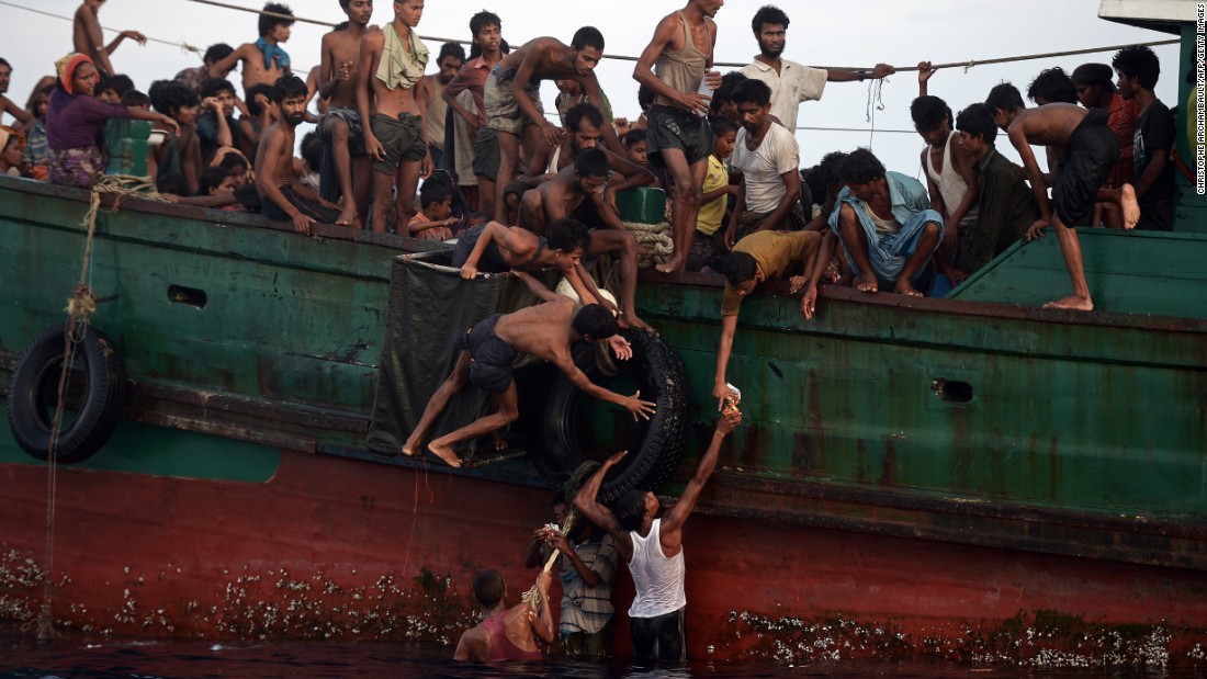 Rohingya migrants pass food supplies dropped by a Thai army helicopter to others aboard the boat. The Indonesian spokesman said Indonesia was currently providing food and shelter to 582 migrants rescued on May 10 and was working with international bodies to provide them documentation and temporary relocation.  