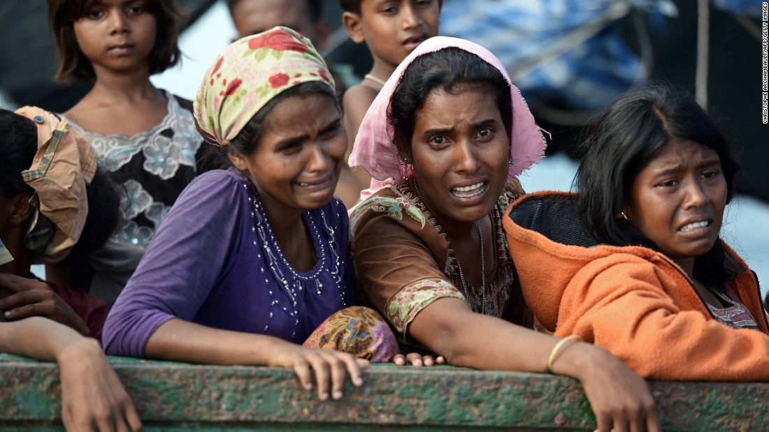 Rohingya migrant women cry as they sit on a boat adrift. Many on board the rickety ship were women and young children, without food or water, looking for a safe harbor to take them in. 