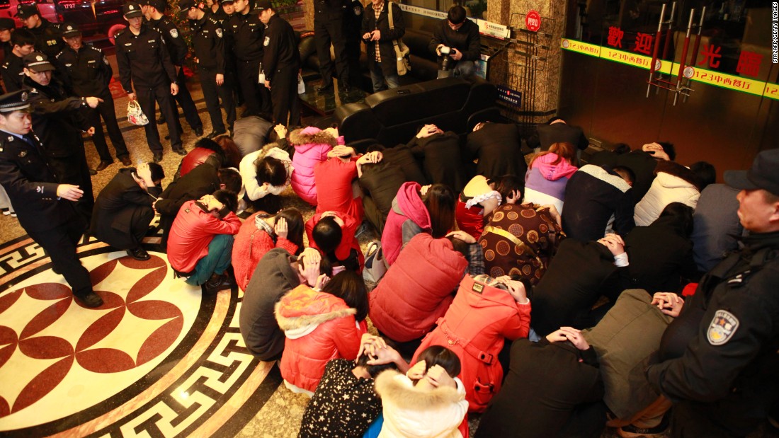This picture taken on February 9, 2014 shows Chinese police rounding up alleged sex workers and clients. The raids lasted several months and their impact is still being felt more than a year later. 