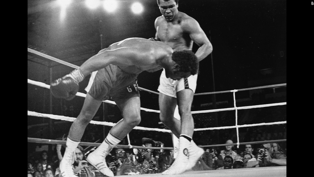 Muhammad Ali watches heavyweight champion George Foreman fall to the canvas during their title bout in Kinshasa, Zaire, in October 1974. Ali&#39;s upset victory over the undefeated Foreman won him back the titles he was stripped of in 1967 for refusing induction into the U.S. Army.