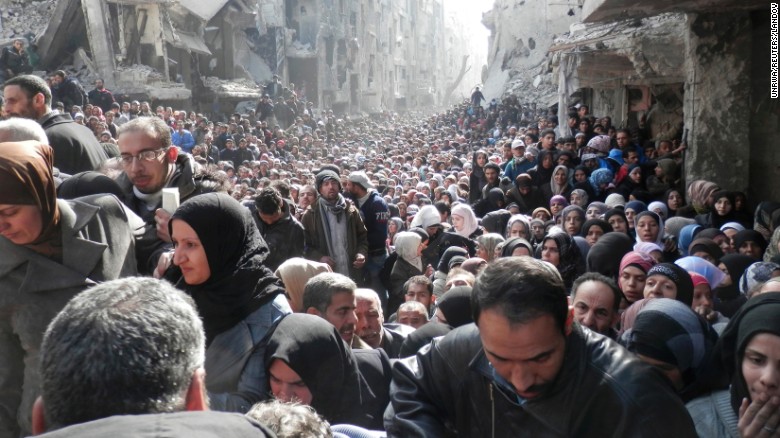 Displaced Syrian residents wait to receive food aid distributed by the UN Relief and Works Agency at the besieged al-Yarmouk camp, south of Damascus, Syria, on January 31, 2014. According to the UN Envoy for Syria, an estimated 400,000 Syrians have been killed since an uprising in March 2011 spiraled into civil war. See how the conflict has unfolded.