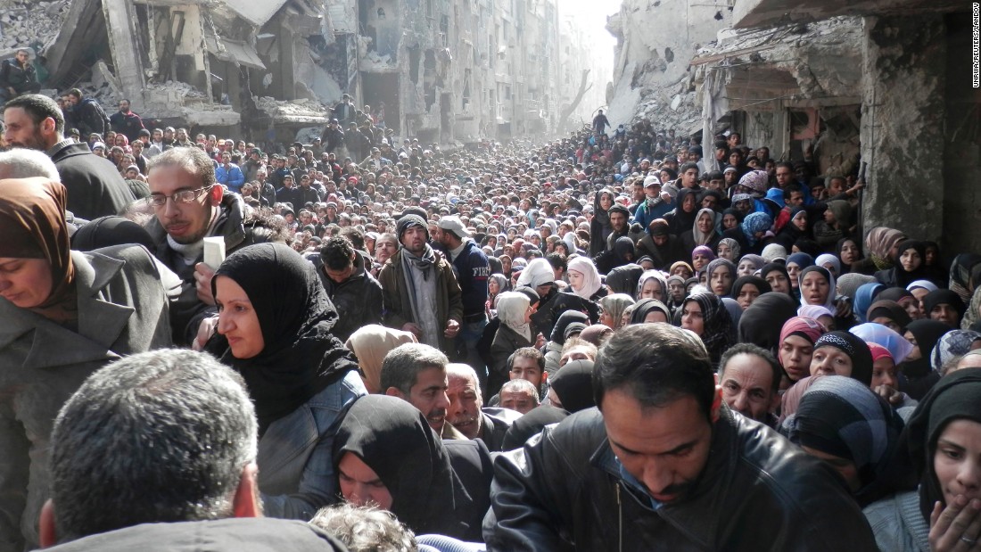 Displaced Syrian residents wait to receive food aid distributed by the UN Relief and Works Agency at the besieged al-Yarmouk camp, south of Damascus, Syria, on January 31, 2014. According to the UN Envoy for Syria, an estimated 400,000 Syrians have been killed since an uprising in March 2011 spiraled into civil war. See how the conflict has unfolded.