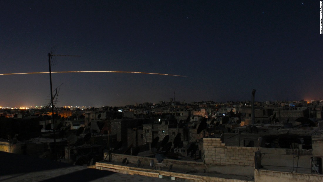 A long-exposure photograph shows a rocket being launched in Aleppo on October 5, 2014.