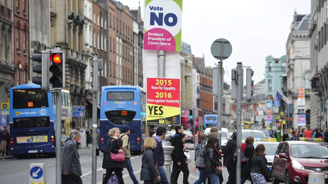 Pesdestrians cross a street next to placards on the same-sex marriage referendum in Dublin, Ireland, on May 22. 