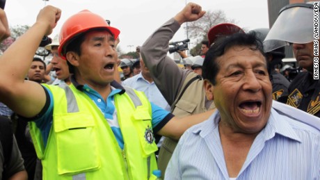 Members of the National Federation of Metallurgical, Mining, Iron and Steel industries of Peru shout slogans as they march towards the Congress in Lima on Tuesday, May 19.