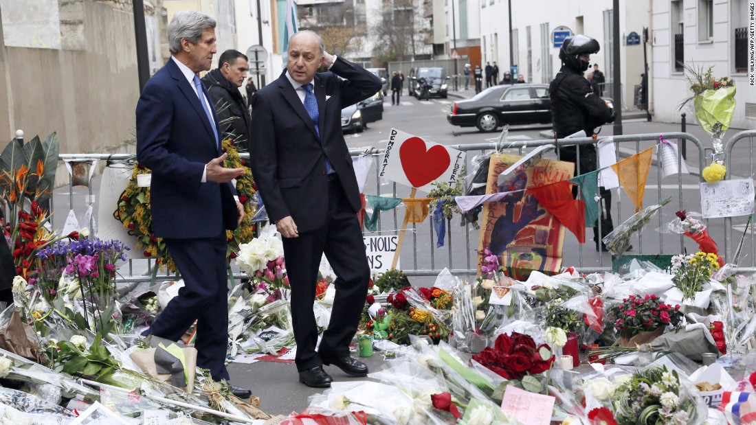 Kerry walks with French Foreign Minister Laurent Fabius in Paris on January 16 through a memorial to the victims killed in the attack on the satirical newspaper Charlie Hebdo.