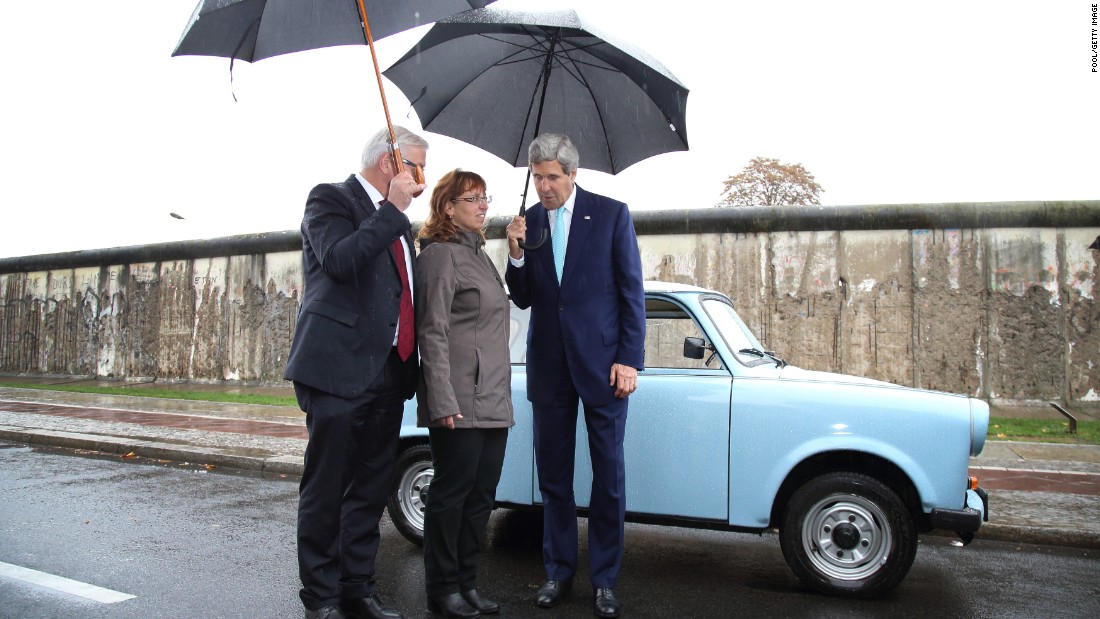 During a tour of the Berlin Wall memorial on October 22, 2014, in Berlin, Kerry and German Foreign Minister Frank-Walter Steinmeier, left, chat with Regina Webert-Lehmann, who in 1989 fled from communist East Germany in her Trabant car (pictured) to Hungary shortly before revolutions swept Eastern Europe. Kerry and Steinmeier met with students and walked along a still-standing portion of the wall that divided East and West Berlin and whose fall 25 years ago marked the end of the Cold War.  