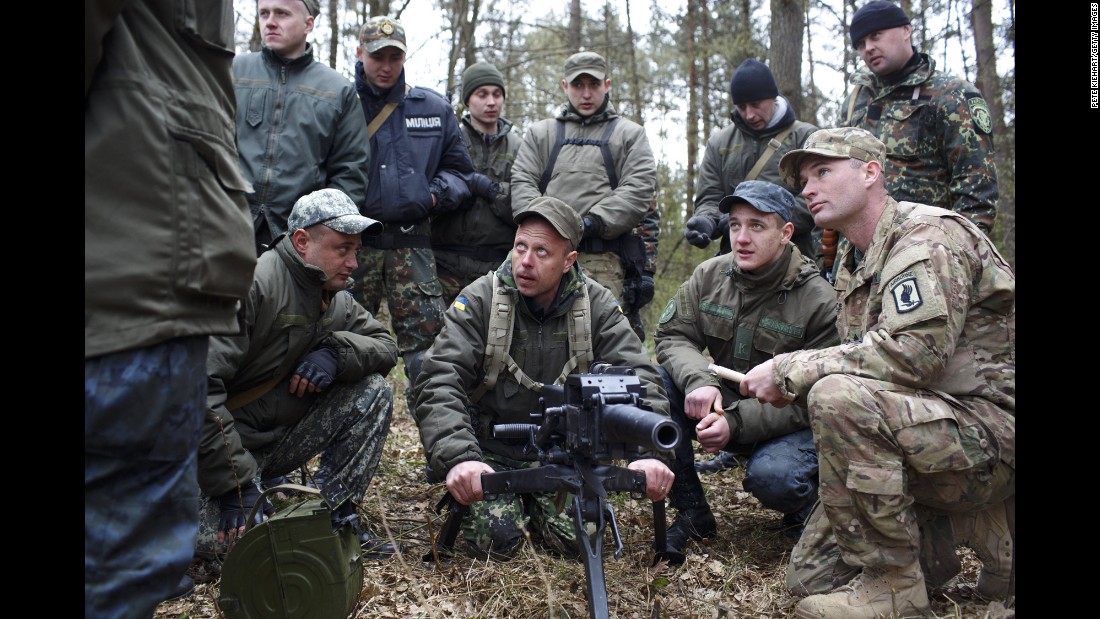 An American soldier, right, trains Ukrainian troops on Tuesday, April 21, near Yavoriv, Ukraine. Operation Fearless Guardian, a six-month training exercise, involves about 300 members of the American 173rd Airborne and about 900 Ukrainian National Guard troops.