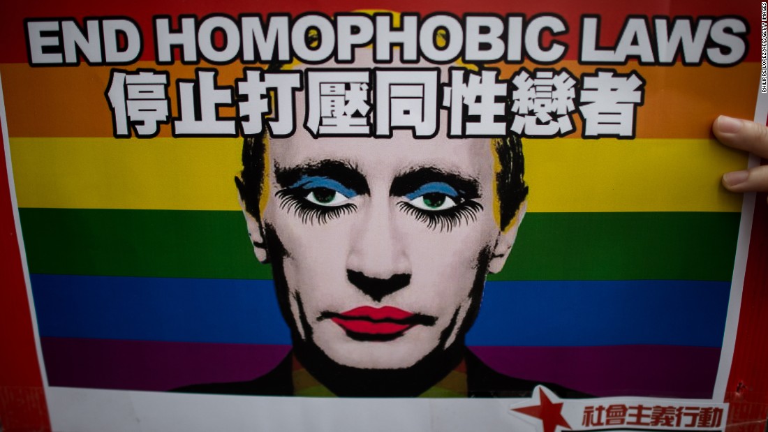 An activist in Hong Kong holds a placard with a slogan over the face of Russian President Vladimir Putin during a demonstration against Russia&#39;s anti-gay legislation on the day of the opening ceremony of the Sochi Winter Olympic Games in February, 2014.