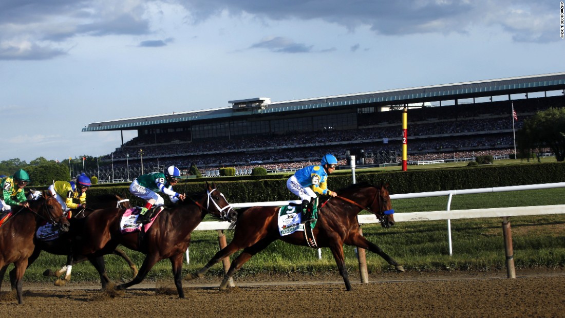 American Pharoah leads the field entering turn three.