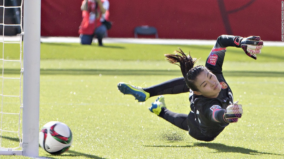 Chinese goalkeeper Wang Fei tries in vain to stop a penalty kick by Canada&#39;s Christine Sinclair. The goal came late in second-half stoppage time.