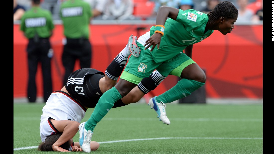 Germany&#39;s Celia Sasic falls head first into the turf after a collision with Ivory Coast&#39;s Sophie Aguie on Sunday, June 7. Germany defeated Ivory Coast 10-0 in Ottawa.