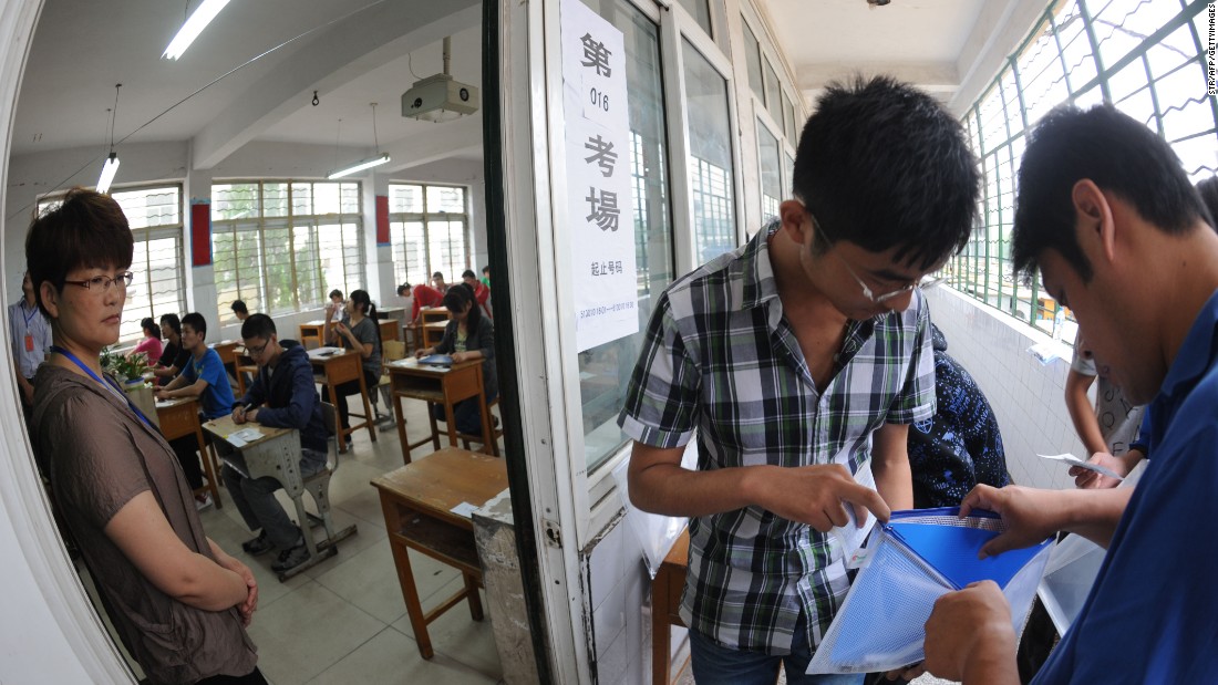 A Chinese student gets his belongings searched before he enters the room to take the tough college entrance exams or Gaokao, in east China&#39;s Anhui province on June 7, 2012. 