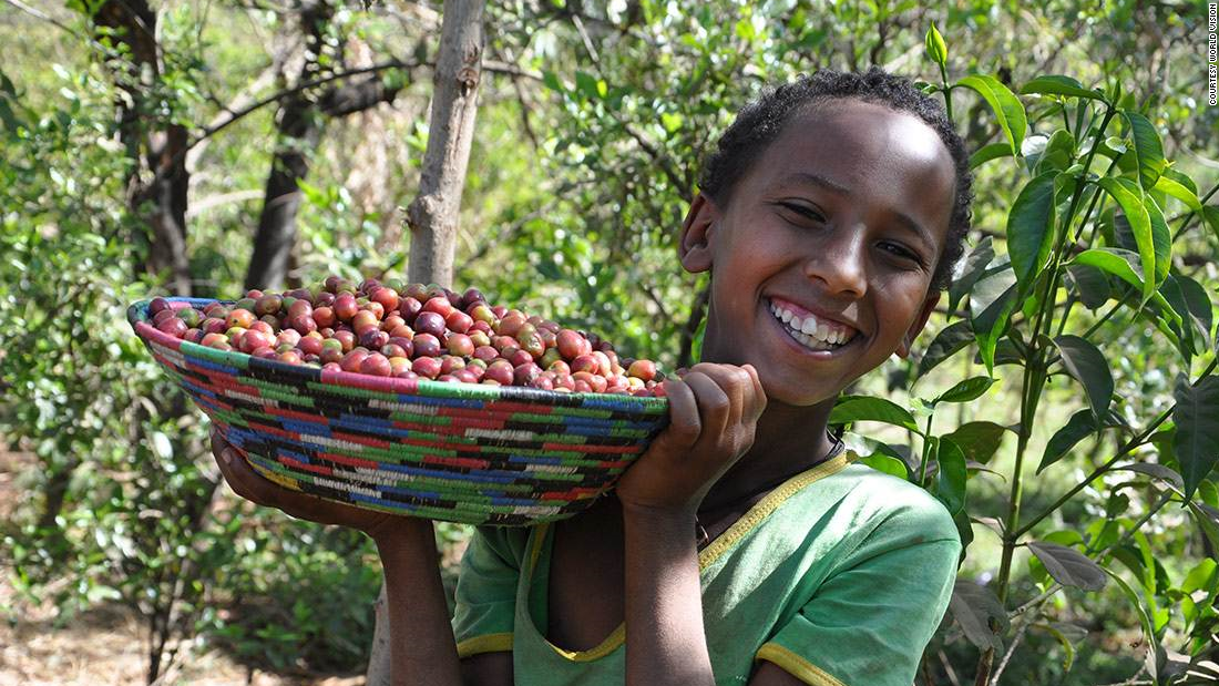 Dukale&#39;s daughter shows off a bowl of coffee cherries.