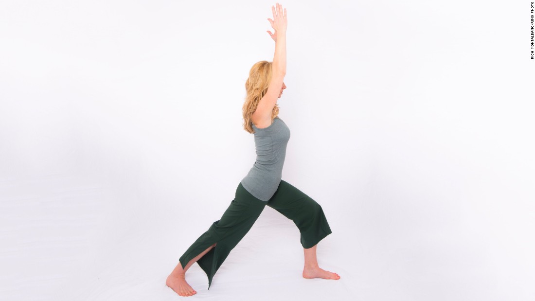 From standing, step back into a lunge but drop your back heel and point your toes out 45 degrees. Keep your back leg straight with your forward knee flexed above your ankle. Lift your arms overhead, shoulder-distance apart. Hold for five long, deep breaths. Repeat on the other side.