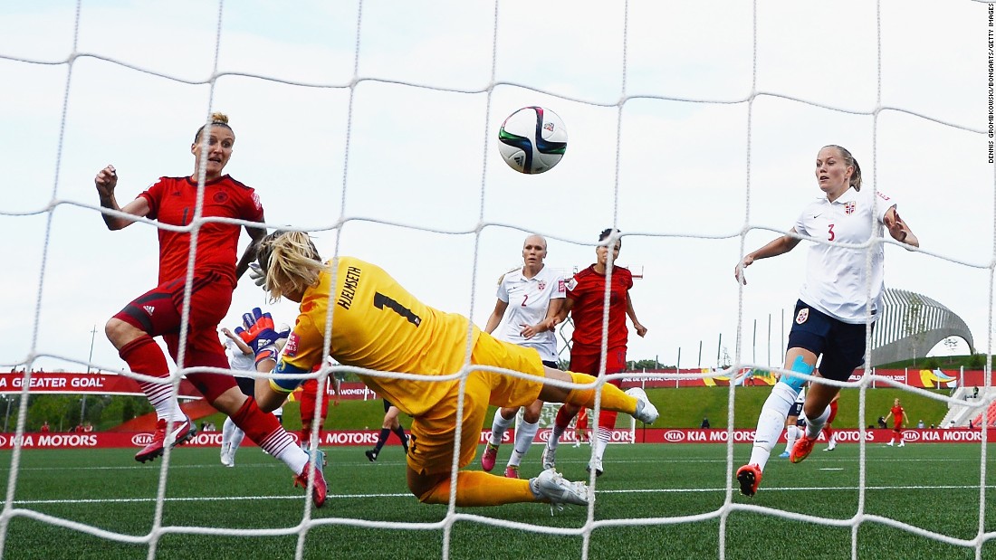 Germany&#39;s Anja Mittag, left, scores a goal past Norway goalkeeper Ingrid Hjelmseth during a match in Ottawa on June 11. The final score was 1-1.