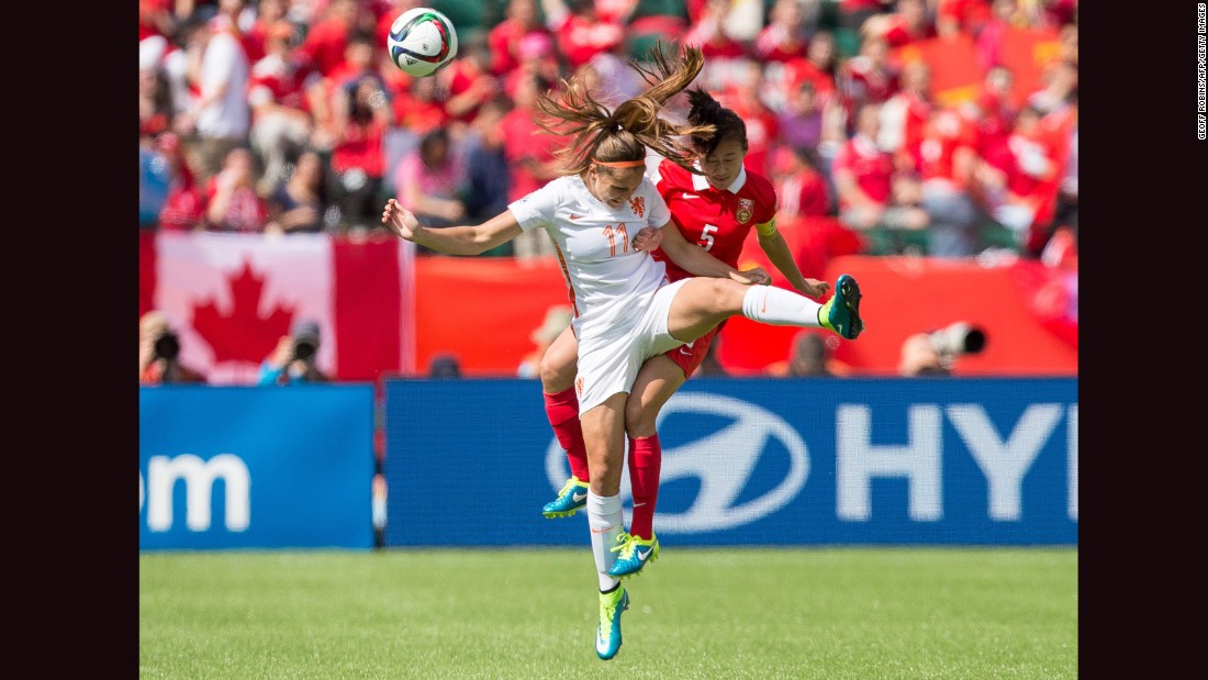 Martens, left, and China&#39;s Haiyan Wu compete for a header.