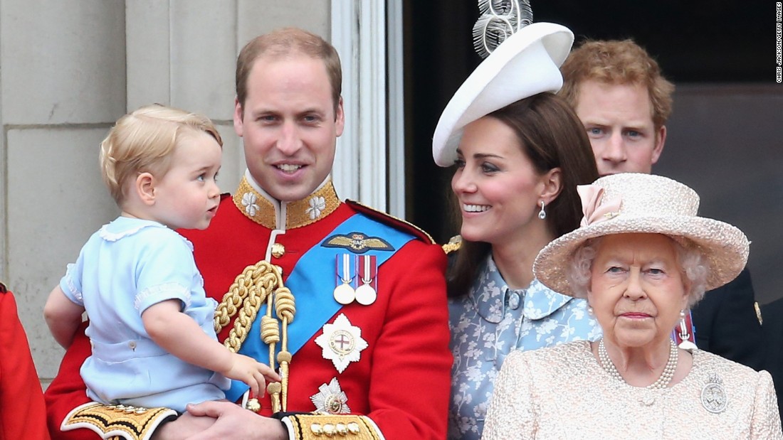 Prince George of Cambridge is held by Prince William, Duke of Cambridge as the family looks on from the balcony of Buckingham Palace.