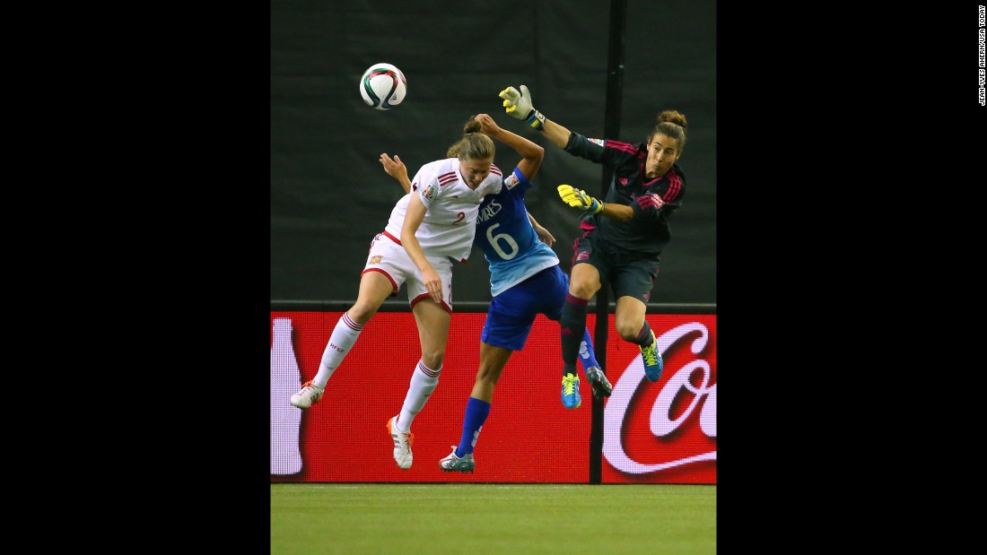 Spain&#39;s Celia Jimenez, left, leaps for the ball near Brazil&#39;s Tamires and Spanish goalkeeper Ainhoa Tirapu during a match in Montreal on June 13. Brazil defeated Spain 1-0. 