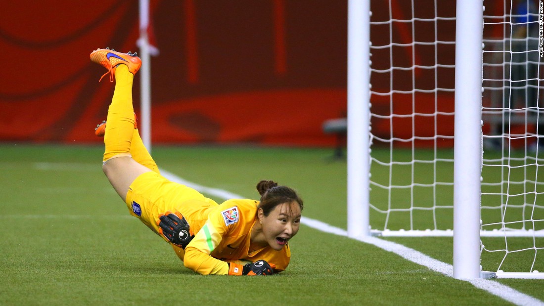 South Korean goalkeeper Kim Jungmi dives as a shot by Costa Rica goes wide of the goal.