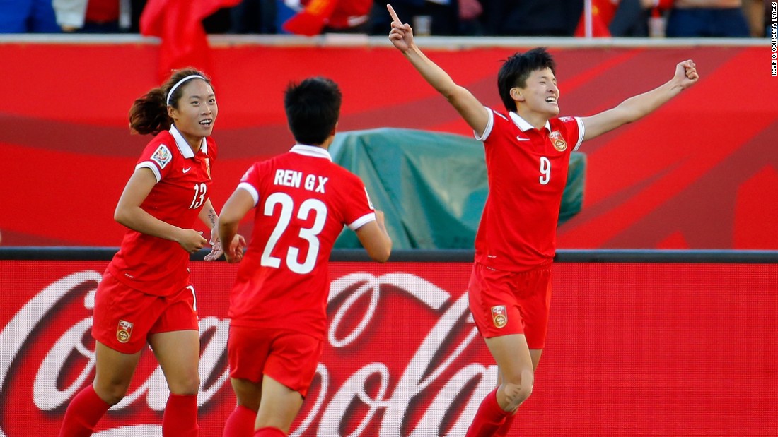 Wang, right, celebrates after scoring China&#39;s second goal.