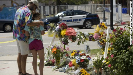 A woman prays at a makeshift memorial near the Emanuel AME Church June 18, 2015 in Charleston, South Carolina, after a mass shooting at the Church on the evening of June 17, 2015. US police on Thursday arrested a 21-year-old white gunman suspected of killing nine people at a prayer meeting in one of the nation&#39;s oldest black churches in Charleston, an attack being probed as a hate crime. The shooting at the Emanuel African Methodist Episcopal Church in the southeastern US city was one of the worst attacks on a place of worship in the country in recent years, and comes at a time of lingering racial tensions