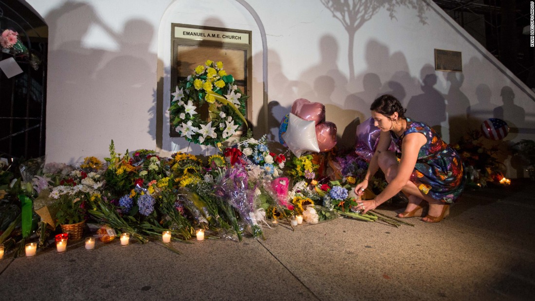 A woman places flowers outside the church on June 18.