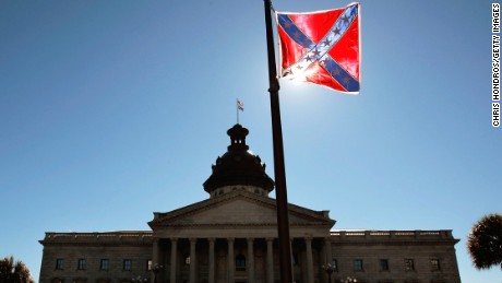 COLUMBIA, SC - JANUARY 21:  A Confederate flag that&#39;s part of a Civil War memorial on the grounds of the South Carolina State House flies over a Martin Luther King  Day rally January 21, 2008 in Columbia, South Carolina.  All three major Democratic candidates for President spoke to a large crowd on the state house grounds.  (Photo by Chris Hondros/Getty Images) 